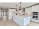 Spacious kitchen featuring white cabinets, modern appliances, and a sleek center island at 5575 Moosehead Cir, Longmont, CO 80503