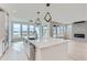 Open-concept kitchen with a large island, stainless steel appliances, and plenty of natural light at 5575 Moosehead Cir, Longmont, CO 80503