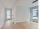 Bright living room featuring light hardwood floors, recessed lighting, and a modern light fixture at 5575 Moosehead Cir, Longmont, CO 80503