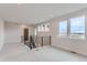 Bright living room with modern railing, large windows offering great views, and recessed lighting at 5575 Moosehead Cir, Longmont, CO 80503