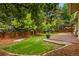 Backyard featuring a wood deck with pergola and beautiful landscaping with green grass and a wooden fence at 142 S Fillmore Ave, Louisville, CO 80027