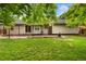 Well-maintained backyard with a lush lawn, a wooden deck and a charming patio area at 142 S Fillmore Ave, Louisville, CO 80027