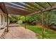 Landscaped backyard featuring a patio, wooden deck, pergola, and mature trees at 142 S Fillmore Ave, Louisville, CO 80027