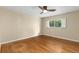 Bright bedroom features a ceiling fan, window with white shutters, and beautiful hardwood floors at 142 S Fillmore Ave, Louisville, CO 80027