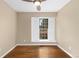 Neutral bedroom showcasing hardwood floors, ceiling fan, and a window with white shutters at 142 S Fillmore Ave, Louisville, CO 80027