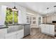 Bright kitchen showcasing stainless steel appliances, white cabinets, and an open design at 142 S Fillmore Ave, Louisville, CO 80027