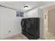 Laundry room featuring modern black washer and dryer units and white cabinets at 142 S Fillmore Ave, Louisville, CO 80027