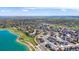 Expansive aerial view of homes adjacent to a lake with lush greenery and smooth roads at 936 Sunflower St, Louisville, CO 80027