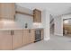 Basement bar area featuring wooden cabinets, a sink, and beverage refrigerator at 936 Sunflower St, Louisville, CO 80027
