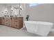 Bathroom boasts a modern tub, double vanity, mirrors and wooden cabinets at 936 Sunflower St, Louisville, CO 80027
