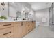 Modern bathroom showcasing double vanity, mirrors, bath and tiled floor at 936 Sunflower St, Louisville, CO 80027