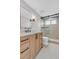 Modern bathroom with a sleek vanity, herringbone tile floor, and a glass-enclosed shower with black hardware at 936 Sunflower St, Louisville, CO 80027