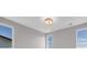 Bedroom featuring three windows, blue sky and modern light fixture at 936 Sunflower St, Louisville, CO 80027