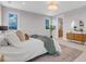 Spacious bedroom with a comfortable bed, decorative rug, and view into ensuite bathroom at 936 Sunflower St, Louisville, CO 80027