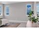 Bedroom featuring two windows with exterior views, plant, carpet, bed and side table at 936 Sunflower St, Louisville, CO 80027