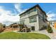 Contemporary three-story home features a deck, modern siding, manicured landscaping, and a spacious backyard at 936 Sunflower St, Louisville, CO 80027