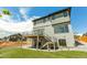 Contemporary three-story home features a deck, modern siding, manicured landscaping, and a spacious backyard at 936 Sunflower St, Louisville, CO 80027