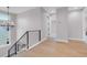 Upstairs hallway with black railings, light hardwood floors, and open doorways at 936 Sunflower St, Louisville, CO 80027