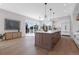 Bright open kitchen with large island, modern lighting, and stainless appliances, opens to the outside at 936 Sunflower St, Louisville, CO 80027