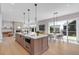Open floor plan with kitchen island, modern lighting, dining area, and fireplace at 936 Sunflower St, Louisville, CO 80027