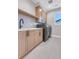 Modern laundry room featuring front load machines, tile floor and sink at 936 Sunflower St, Louisville, CO 80027
