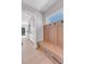 Mudroom with wood bench, storage drawers, hooks, and access to the kitchen and front entry at 936 Sunflower St, Louisville, CO 80027
