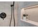 Close up of shower with shower head, tiled niche, and toiletries at 936 Sunflower St, Louisville, CO 80027