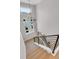 Staircase with modern metal railing, light wood steps, and a chandelier at the top at 936 Sunflower St, Louisville, CO 80027