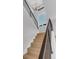 Staircase with modern metal railing, light wood steps and a large window at the top at 936 Sunflower St, Louisville, CO 80027