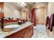 Bathroom featuring dual sinks, granite countertops, tile flooring, and tub/shower with tile surround at 220 Cottonwood Cir, Breckenridge, CO 80424