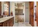 Bathroom featuring a glass enclosed shower, stone accents, and dual sinks at 220 Cottonwood Cir, Breckenridge, CO 80424