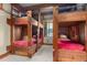 Rustic bunk room with wooden bunk beds, cozy bedding, and charming window views at 220 Cottonwood Cir, Breckenridge, CO 80424
