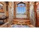 Elegant foyer with stone walls, wood floors, and mountain views at 220 Cottonwood Cir, Breckenridge, CO 80424
