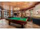 Game room featuring a billiard table, fireplace, stone accents, and window views at 220 Cottonwood Cir, Breckenridge, CO 80424