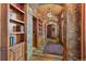 Hallway with stone archways, wood floors, built in cabinets, and decorative lighting at 220 Cottonwood Cir, Breckenridge, CO 80424