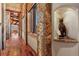 Hallway boasting stone columns, wooden floors, and a decorative bear statue at 220 Cottonwood Cir, Breckenridge, CO 80424