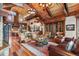 Living room featuring a wood ceiling, a stone fireplace, and a view of the kitchen at 220 Cottonwood Cir, Breckenridge, CO 80424
