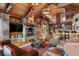 Living room with a stone fireplace, a wood ceiling, and a view of the kitchen at 220 Cottonwood Cir, Breckenridge, CO 80424