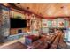 Spacious living room boasts a stone fireplace, wood-paneled ceiling, and comfortable leather seating at 220 Cottonwood Cir, Breckenridge, CO 80424