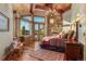 Cozy main bedroom with stone fireplace, private balcony, and scenic mountain views at 220 Cottonwood Cir, Breckenridge, CO 80424