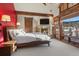 Main bedroom featuring a stone fireplace, wood beams, and large windows with mountain views at 220 Cottonwood Cir, Breckenridge, CO 80424