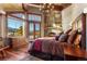 Cozy main bedroom with stone fireplace, private balcony, and scenic mountain views at 220 Cottonwood Cir, Breckenridge, CO 80424