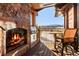 Inviting outdoor patio featuring a stone fireplace, grill, and mountain views at 220 Cottonwood Cir, Breckenridge, CO 80424