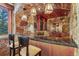 Stylish wet bar showcasing granite countertop, stone accents, custom cabinetry, and wood trim at 220 Cottonwood Cir, Breckenridge, CO 80424