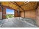 Spacious barn interior with open door leading to outside, and insulated roof at 225 Briscoe Ln, Castle Rock, CO 80109