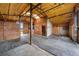 Barn interior featuring stalls, tack room, open doorway, and skylights at 225 Briscoe Ln, Castle Rock, CO 80109