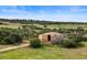 Exterior view of barn located on large property with meadow at 225 Briscoe Ln, Castle Rock, CO 80109