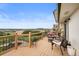 Angle view of a deck showcasing wood railing, patio furniture set, and a scenic view of rolling green hills at 225 Briscoe Ln, Castle Rock, CO 80109