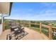 Wide angle view of the deck featuring railing, outdoor seating, an end table, and a view of a lush green hillside at 225 Briscoe Ln, Castle Rock, CO 80109