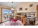 Bright dining area with red cushioned seating, glass table, and beautiful views through the sliding glass doors at 225 Briscoe Ln, Castle Rock, CO 80109